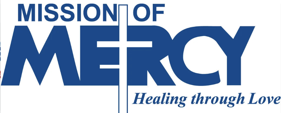 Blue text reads “MISSION OF MERCY” with a cross forming the letter “E” in “MERCY.” Below, in italic script, it says, “Healing through Love.” The design conveys a faith-based message.